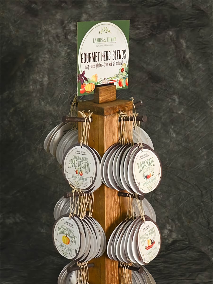 various gourmet herb dip packages hanging from wooden display stand