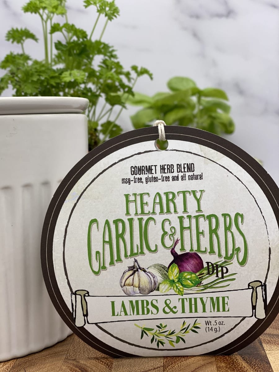 Hearty Garlic Herbs Dip product package displayed with dip chiller on wooden cutting board