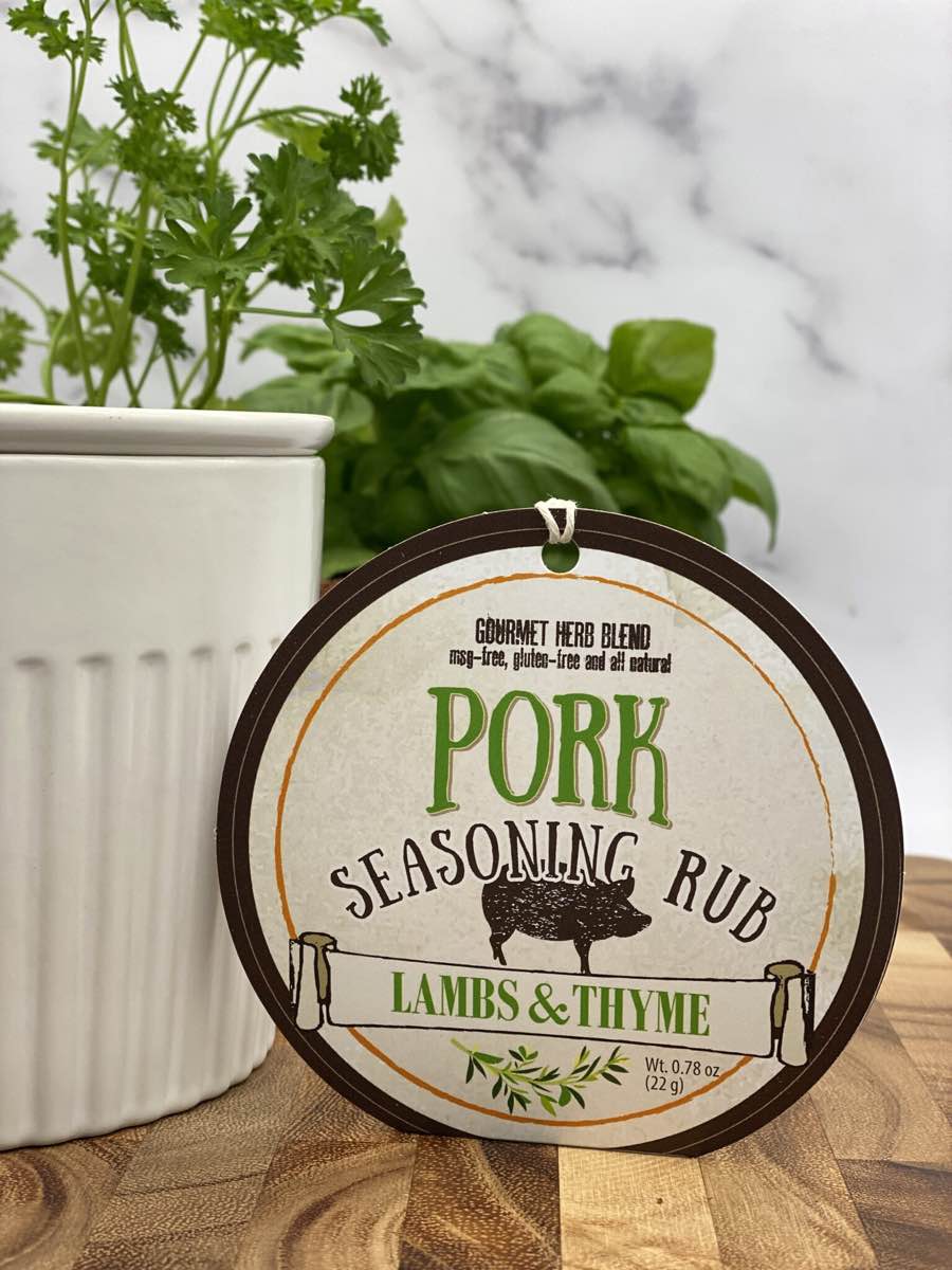 Pork Seasoning Rub package with dip chiller and herbs on wooden cutting board