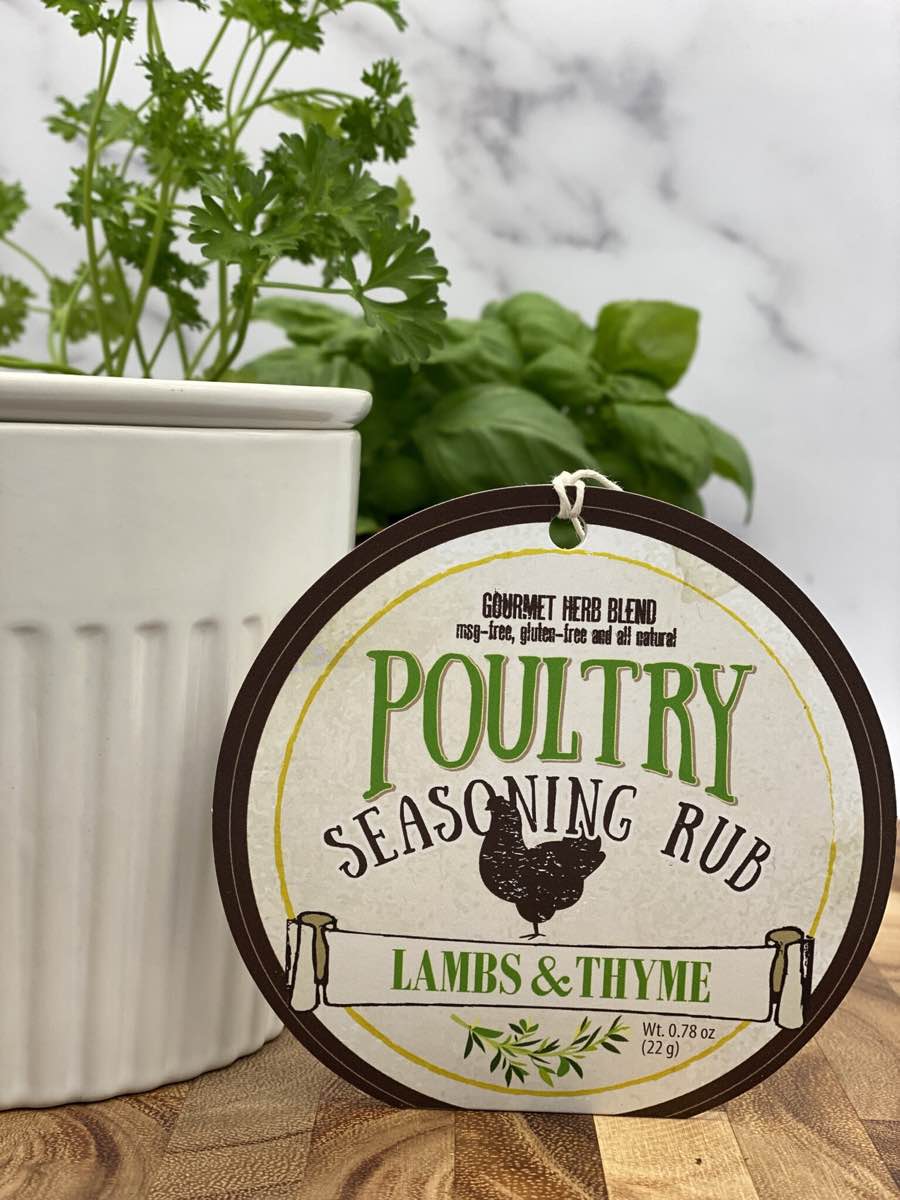 Poultry Seasoning Rub package with dip chiller and herbs on wooden cutting board