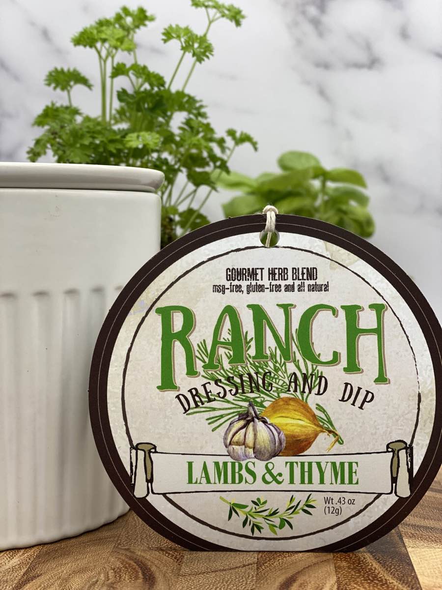 Ranch dressing and dip product package displayed with dip chiller on wooden cutting board