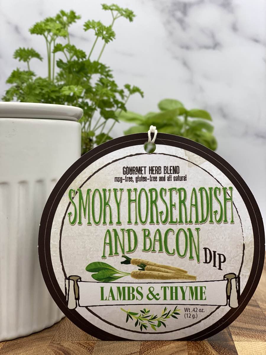 Smoky Horseradish Bacon Dip product package displayed with dip chiller on wooden cutting board