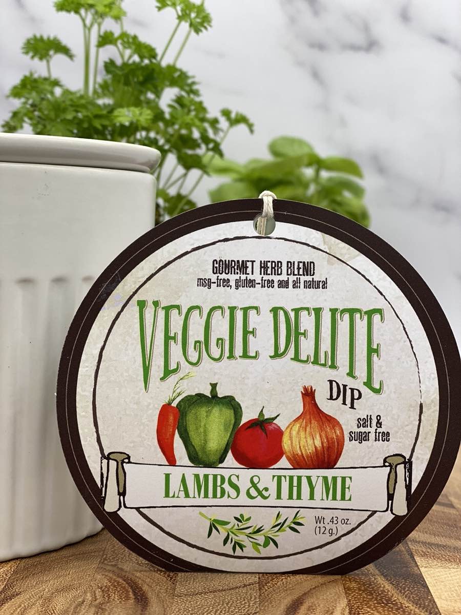 Veggie Delite Dip product package displayed with dip chiller on wooden cutting board