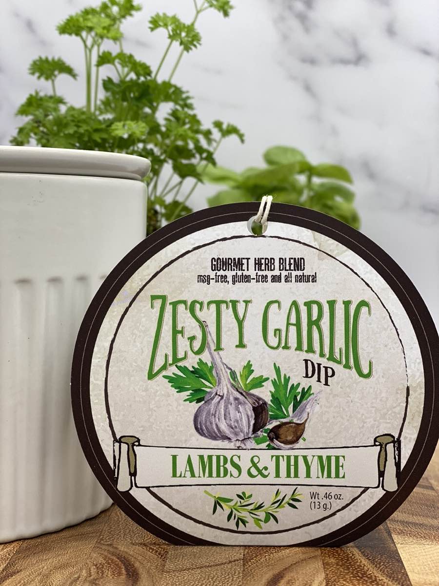 Zesty Garlic Dip product package displayed with dip chiller on wooden cutting board