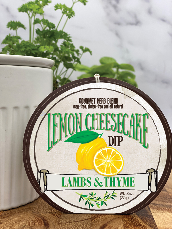 Lemon Cheesecake Dip product package displayed with dip chiller on wooden cutting board