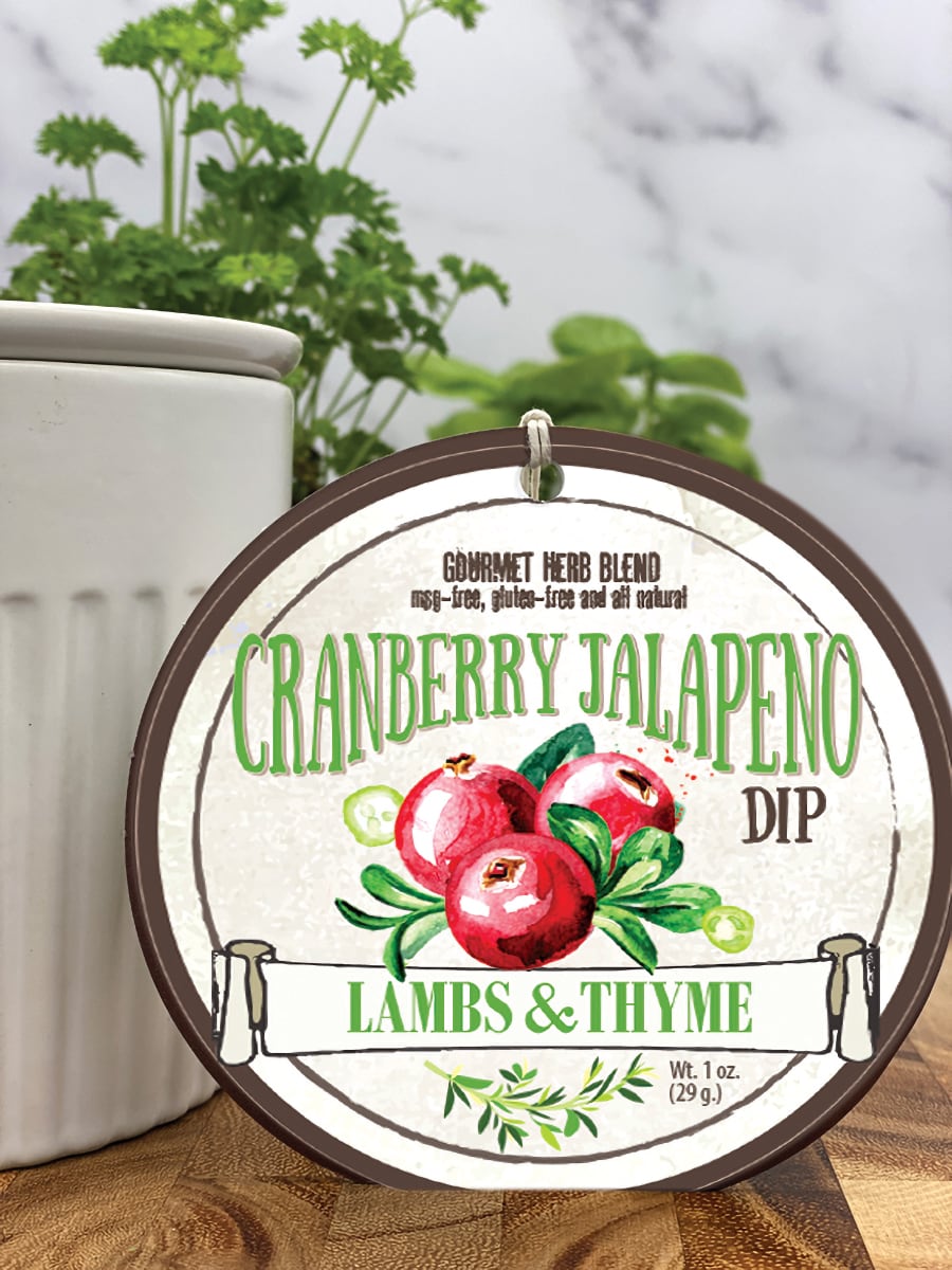 Cranberry Jalapeno Dip product package displayed with dip chiller on wooden cutting board