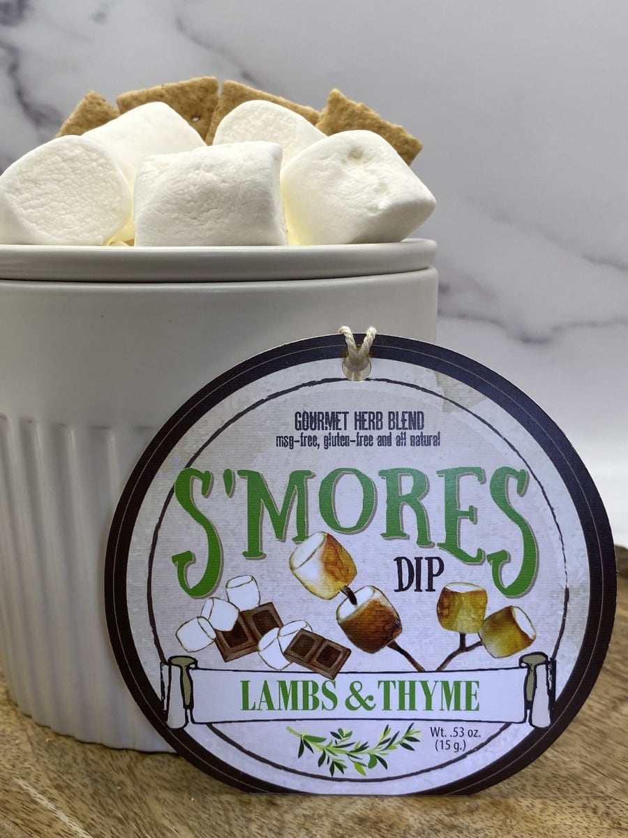 S'mores Dip product package displayed with dip chiller on wooden cutting board